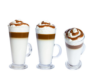 Coffee macchiato with whipped cream and caramel in a glass mug. Isolated object on white background. The photo.