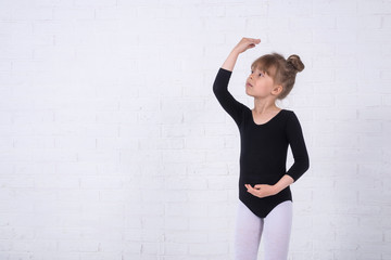 Little girl in the gymnastic swimsuit, free space.