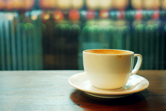 Coffee Cup on the Table in Cafe. Bokeh Lens Flare as background