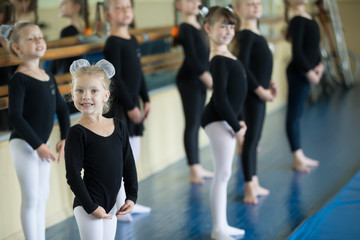 Little girls at the ballet machine. Lesson choreography. Young ballerinas.. Training of the initial...