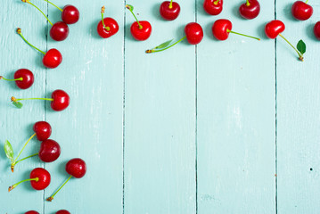 sour cherry fruits on old blue wooden table background