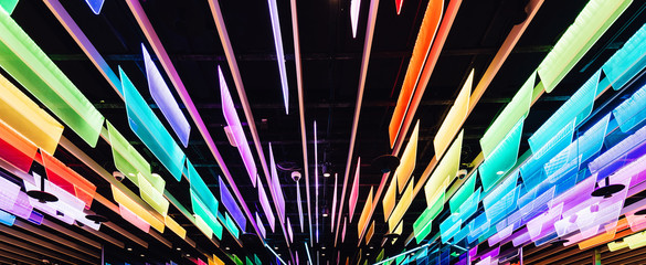 Rainbow colors transparent panels with LED lights that decorated with ceiling. Perspective...