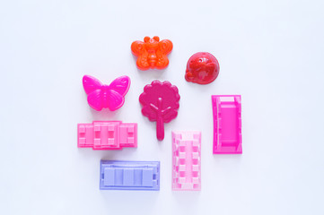 Toys for sand. Children's toy summer sea game. Flat lay. Pink color. Kindergarten playground on outdoor