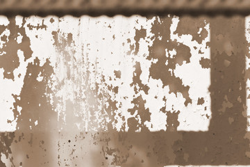 Old painted window behind iron bar close up. Grunge background in brown color