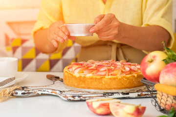 Woman make homemade apple pie. Confectioner make dessert. Apples on the table. Summer fruit dessert. Process of cooking apple pie, top view. Cooking and home concept.