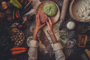 Process of making cooking homemade pasta. Chef make fresh italian traditional pasta. Flat lay. Top view. Frame. Rustic style, toned image.