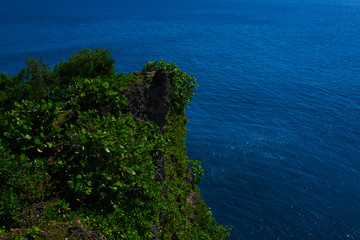 Amazing view of steep cliff and ocean at Uluwatu in Bali.