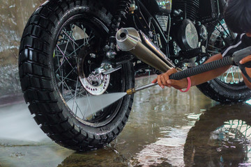 A man cleaning motorcycle 