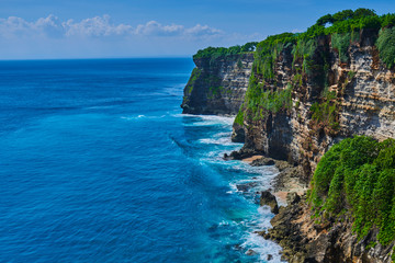 Bali seascape with huge waves and beautiful rocks. Sea beach nature, outdoor Indonesia. Island landscape. Summer holidays at ocean beach. Travel vacation in Indonesia beach. Ecological tourism.