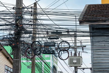 Electricity pole with complicated wire and cable on a concrete pole in Songkhla City Thailand with...