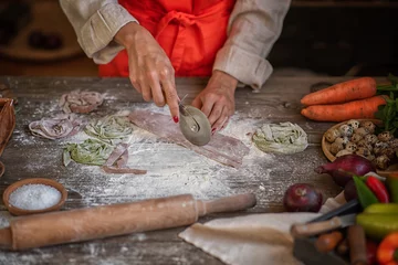 Foto op Canvas View of cook are working. Homemade pasta. Hands preparing dough on wooden table. © eskstock