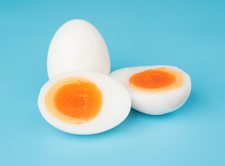 Boiled egg sliced isolated on blue background food object design