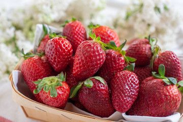 Fresh strawberries in the mug on the wooden table