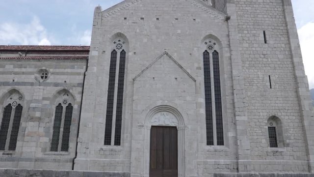 panning shot of church in venzone, this is the back entrance of the building