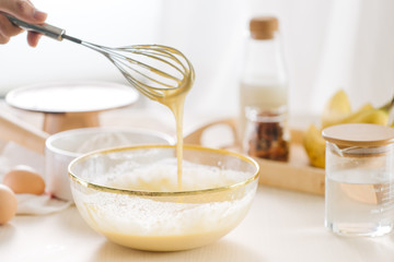 fresh eggs milk and flour on white table