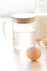 recipe ingredients : eggs, flour, milk, almonds, banana on white background