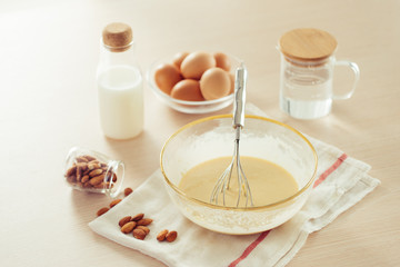 recipe ingredients : eggs, flour, milk, almonds, banana on white background