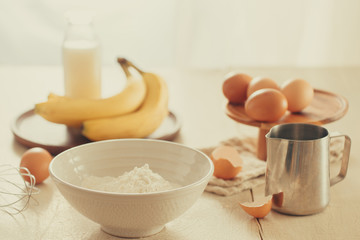 Obraz na płótnie Canvas recipe ingredients : eggs, flour, milk, almonds, banana on white background