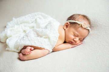 Cute newborn baby is sleeping on a big bed. Copy space and top view