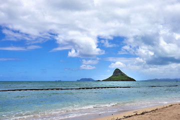 A view of the Chinaman's Hat island seen from a beach near the Kualoa Regional Park at O'ahu, Hawaii. - obrazy, fototapety, plakaty