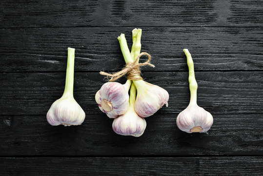 Fresh garlic on a wooden background. Top view. Free space for your text.