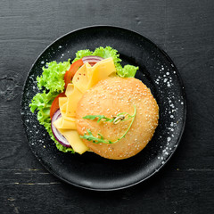 Burger with cheese, tomatoes and onion. Breakfast. Top view. Free space for your text.