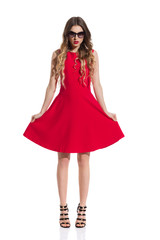 Serious Beautiful Young Woman Is Posing In Red Dress And High Heels