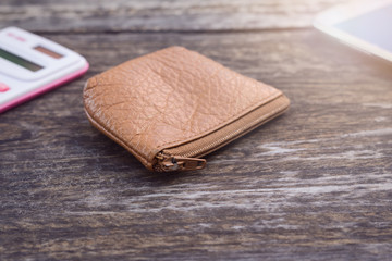 Leather wallet on old wooden desk vintage style.