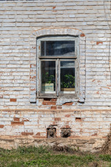 The old buildings built of a brick, destroyed by time and the nature at the beginning of spring in sunny day. Russian remote place.