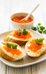 Naklejka na ściany i meble Red caviar in bowl and sandwiches