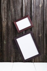 blank picture frames on old weathered wooden wall background