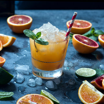 Summer cocktail with crashed ice, juicy summer drink with citrus fruits, square image
