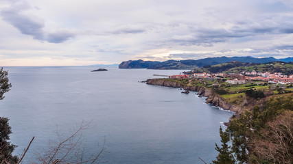 View of the coast of the village of Bermeo on a cloudy day, in the Basque Country