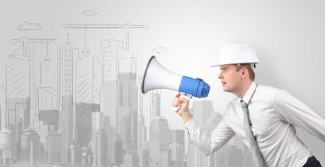 Fototapeta premium Young supervisor architect yelling to a big city panorama 