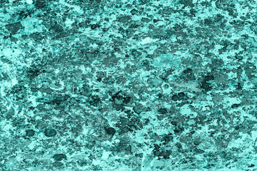 Vintage azure background. Rough painted wall of turquoise color. Imperfect plane of cyan colored. Uneven old decorative toned backdrop of aqzure tint. Texture of teal hue. Ornamental stony surface.