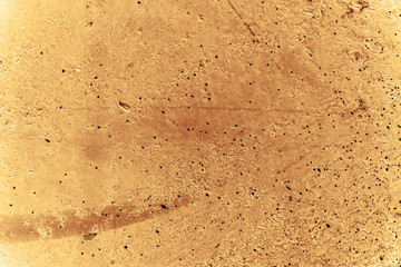 Vintage yellow background. Rough painted wall of aspen gold color. Imperfect plane of golden colored. Uneven old decorative toned backdrop of yellow tint. Texture of gold hue. Ornamental stony surface
