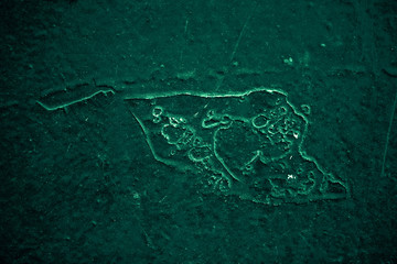 Vintage green background. Rough painted wall of emerald color. Imperfect plane of virid colored. Uneven old decorative toned backdrop of green tint. Texture of emerald hue. Ornamental stony surface.