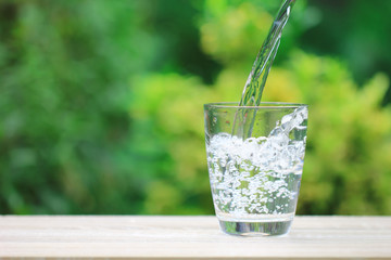 Closeup Glass of water on table nature background © Monthira