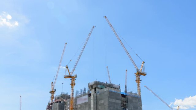 Time lapse of Crane on construction building in sunshine day