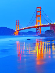 View of Golden Gate Bridge from Marshall's Beach in San Francisco at night.