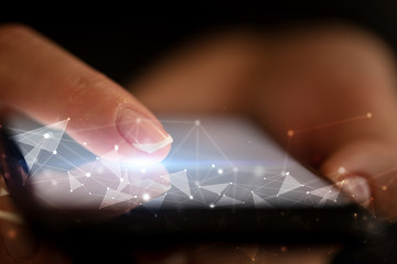 Finger touching phone with human network concept and dark background
