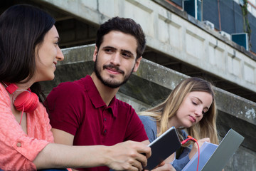 Group of  University students studying together outdoors