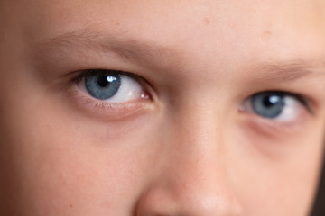 blue eyes of the boy close-up. children's portrait. macro photos of eyes