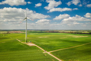 Wind turbines on field and blue sky with clouds
