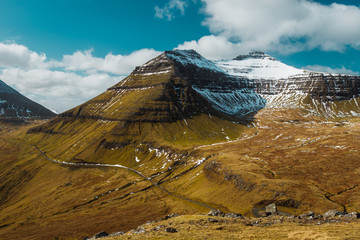View of the snow-covered peak of Sl&aelig;ttaratindur, the highest mountain on the Faroe Islands during a sunny spring day (Faroe Islands, Denmark, Europe)