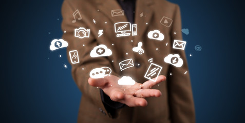 Hand holding application icons and symbols in her hand
