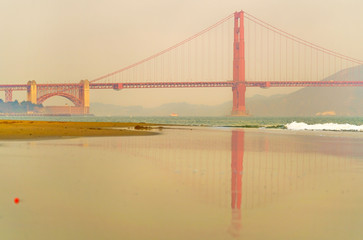 View of Golden Gate Bridge from East Beach in San Francisco at sunrise.