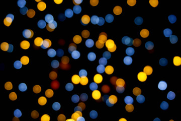 Background and wallpaper colorful abstract with blurred and bokeh of LED party light bubs reflection on black background.