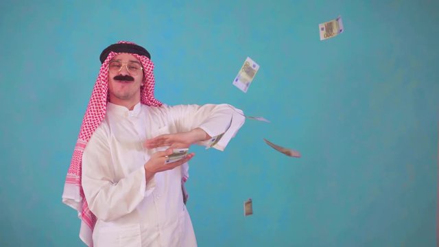 cheerful Arab man with a mustache and traditional clothes with Audi ,throws money