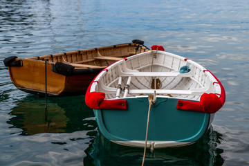 View of boats in the beautiful harbour of Portofino in Liguria coast. Province of Genoa, Italy. Sunny summer day and blue sea. Postcard of Portofino. Travel and vacation concept.